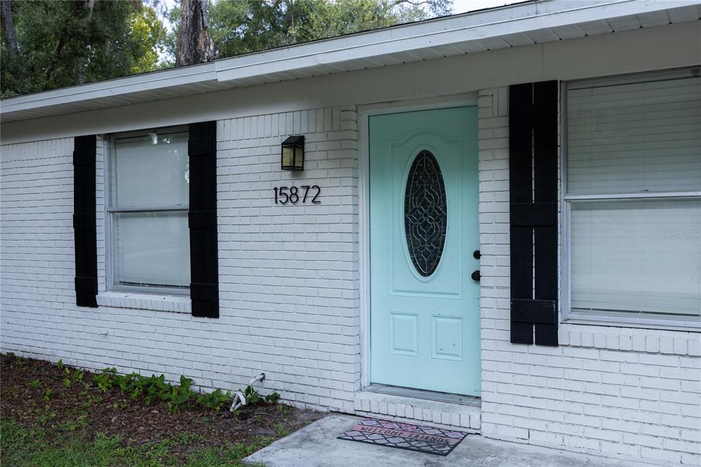 15872 Southwest 133rd Lane Archer, FL 32618 - Photo 3 of 28 a front view of a house with garden