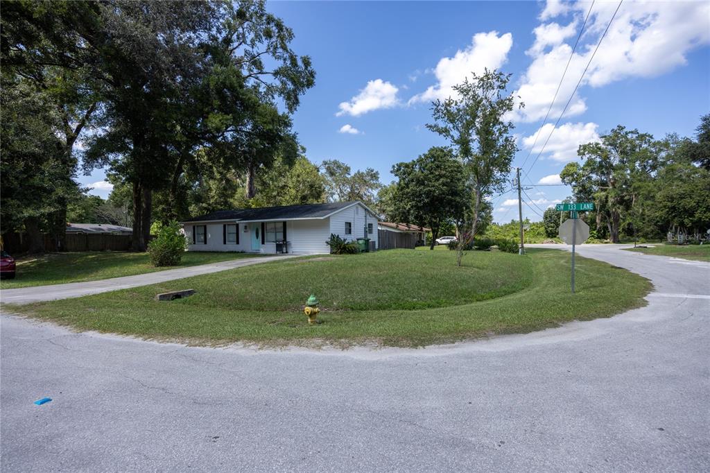 15872 Southwest 133rd Lane Archer, FL 32618 - Photo 5 of 28 a view of a house with a big yard and large trees