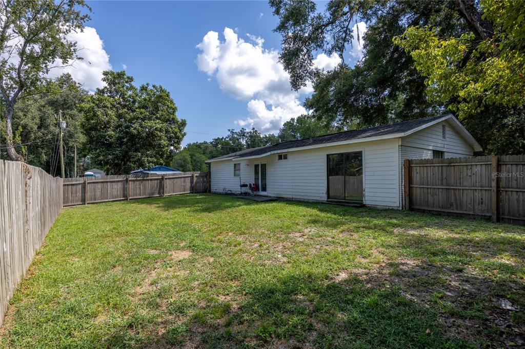 15872 Southwest 133rd Lane Archer, FL 32618 - Photo 10 of 28 a view of a backyard with a garden and tree