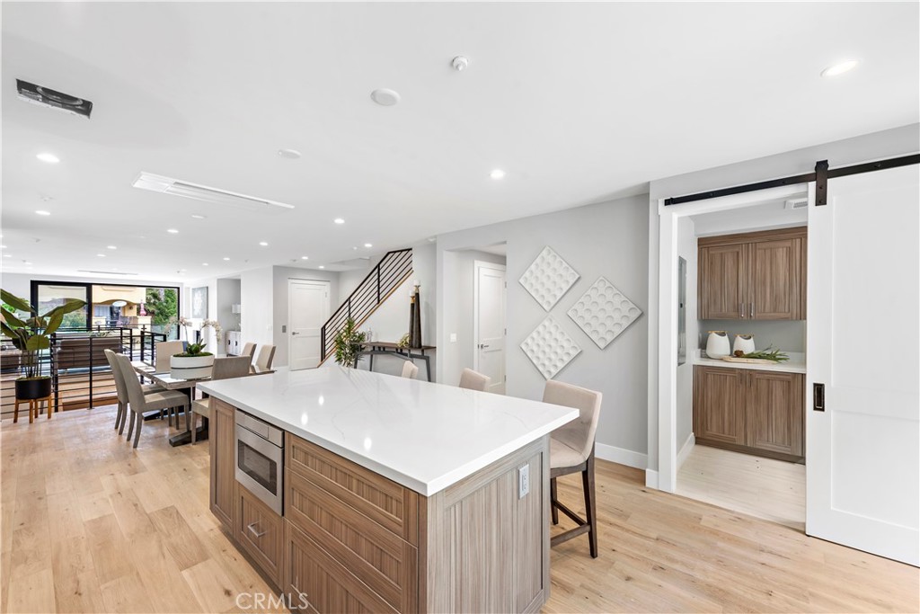 33889 Robles Drive Dana Point, CA 92629 - Photo 1 of 42 a kitchen with a stove a refrigerator and a dining table with wooden floor