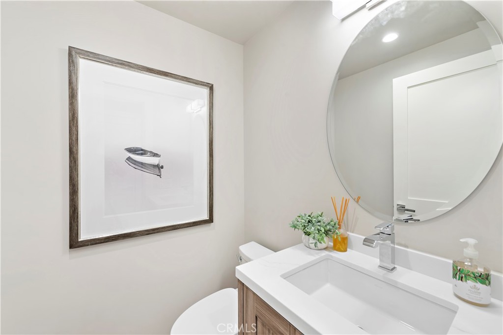 33889 Robles Drive Dana Point, CA 92629 - Photo 21 of 42 a bathroom with a sink a mirror and a toilet
