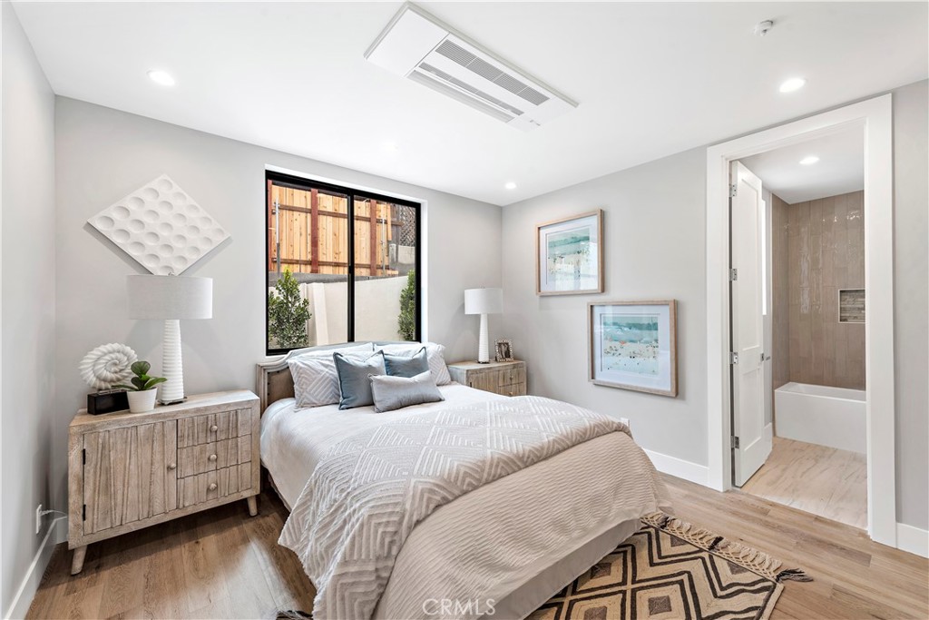 33889 Robles Drive Dana Point, CA 92629 - Photo 24 of 42 a bedroom with a bed and wooden floor