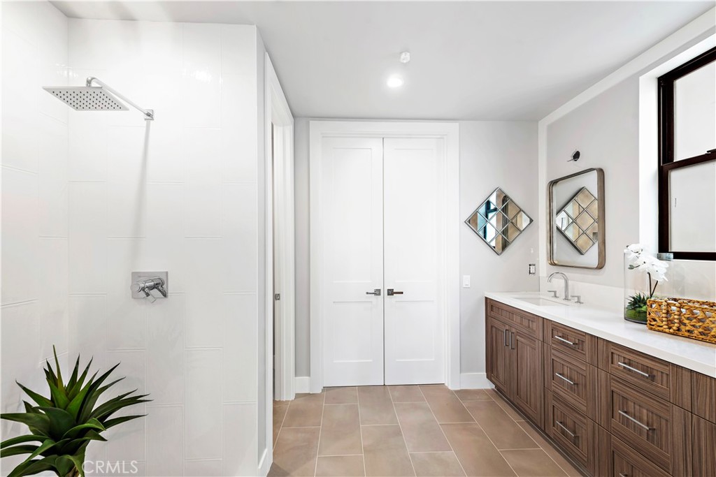 33889 Robles Drive Dana Point, CA 92629 - Photo 32 of 42 a spacious bathroom with a granite countertop sink a mirror and a shower