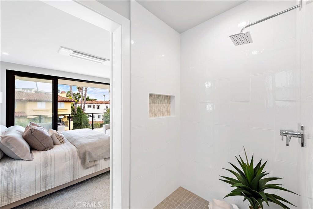 33889 Robles Drive Dana Point, CA 92629 - Photo 33 of 42 a bedroom with a large bed and a large window