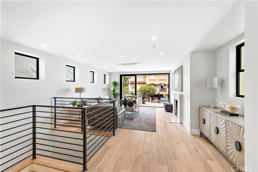 33889 Robles Drive Dana Point, CA 92629 - Photo 4 of 42 a hallway with a white furniture and floor to ceiling window