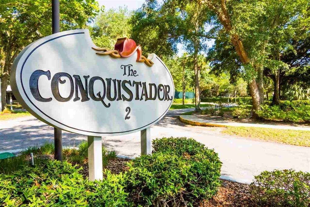a view of swimming pool with a backyard and trees