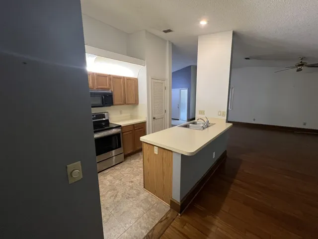 a kitchen with a stove and a refrigerator