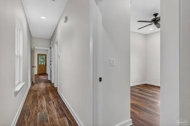a view of a hallway and wooden floor