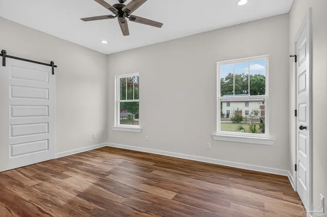 wooden floor in an empty room with a window