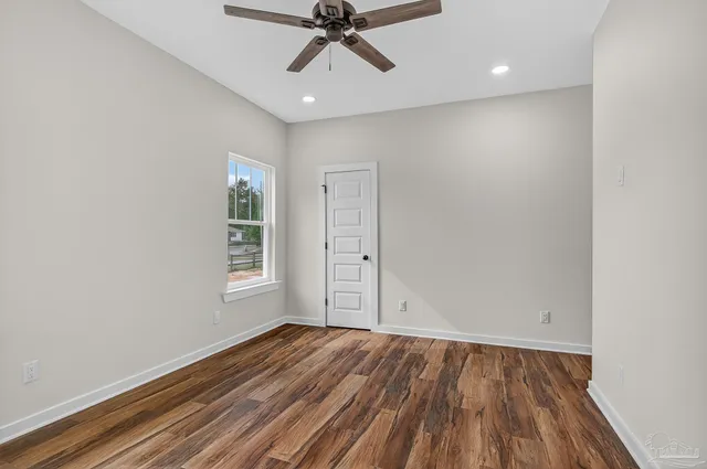 wooden floor in an empty room with a window