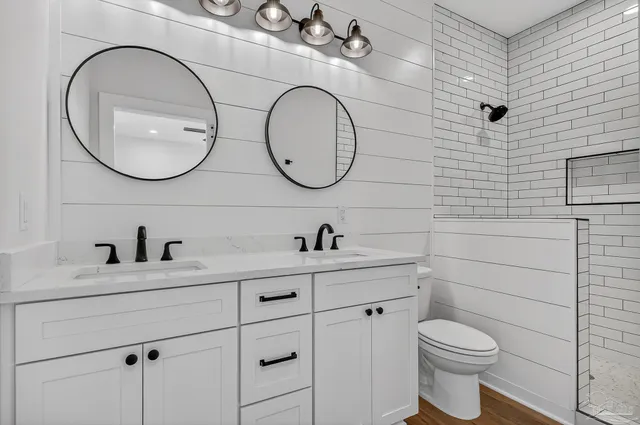 a bathroom with a toilet a sink and mirror