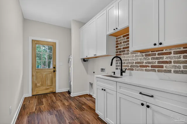 a kitchen with sink and cabinets