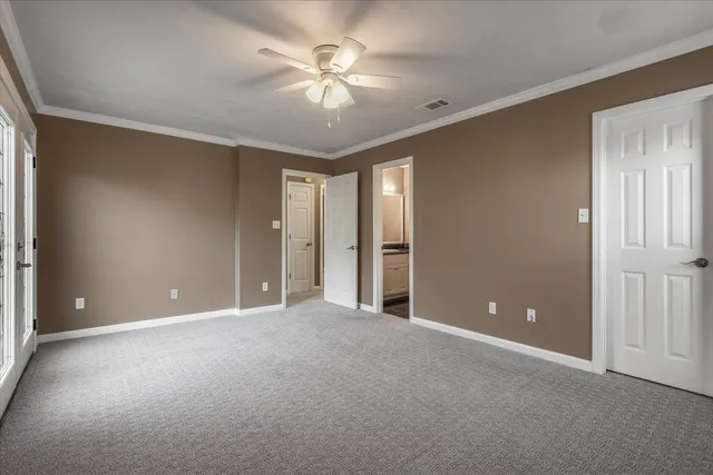 a view of an empty room with a ceiling fan