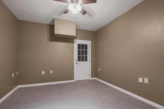 a view of an empty room and a window