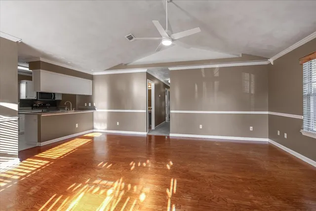 a view of a kitchen with wooden floor and a sink