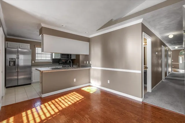 a kitchen with stainless steel appliances granite countertop a refrigerator and a sink