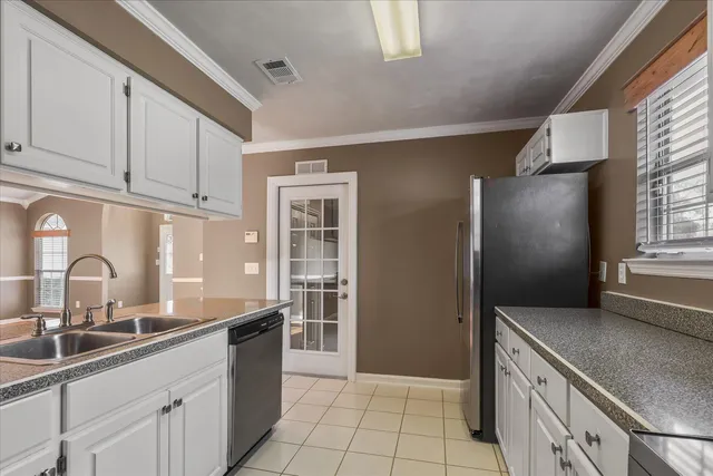a kitchen with granite countertop a sink stove and cabinets