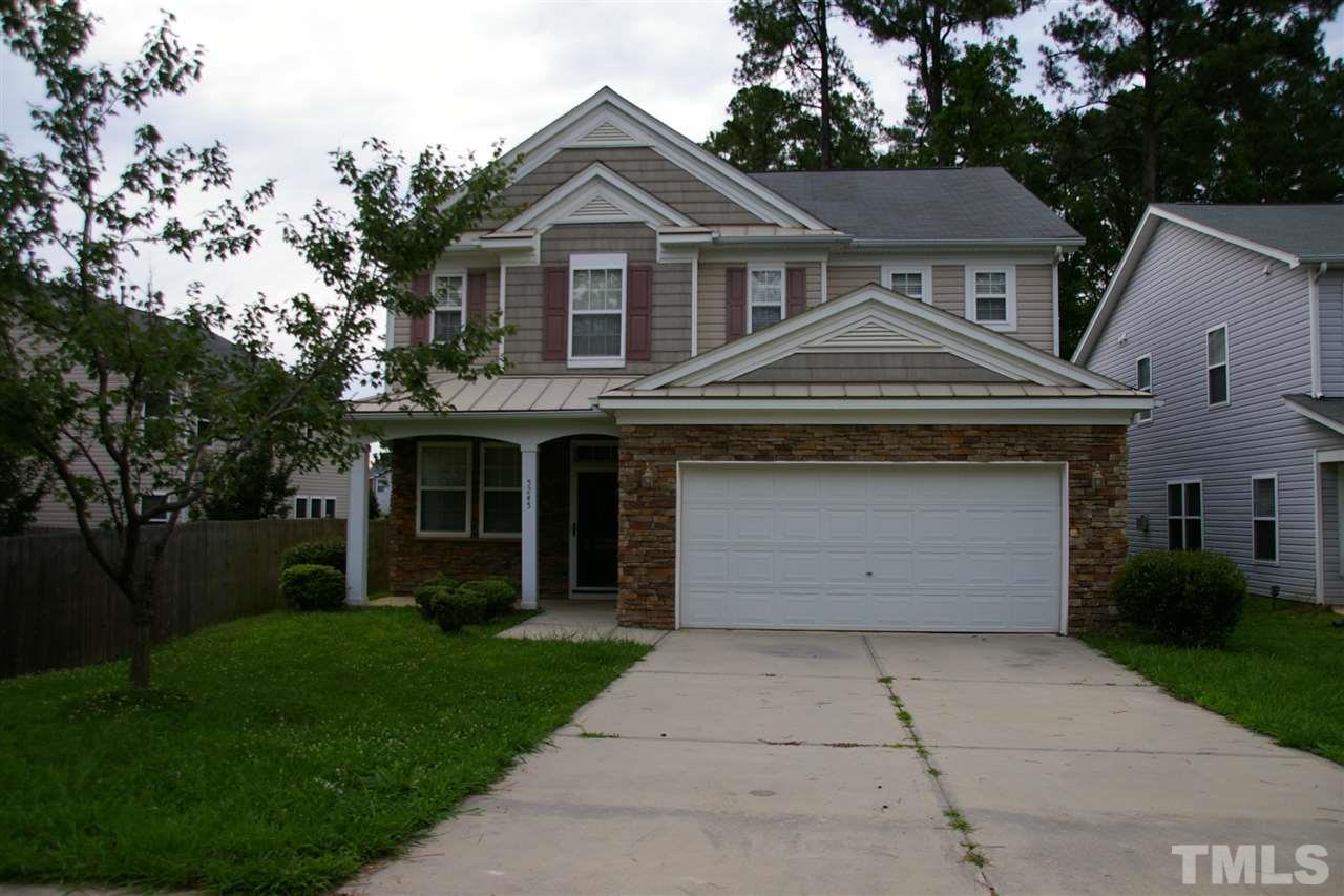 5245 Thornton Road Raleigh, NC 27616 - Photo 1 of 9 a front view of a house with a garden and trees