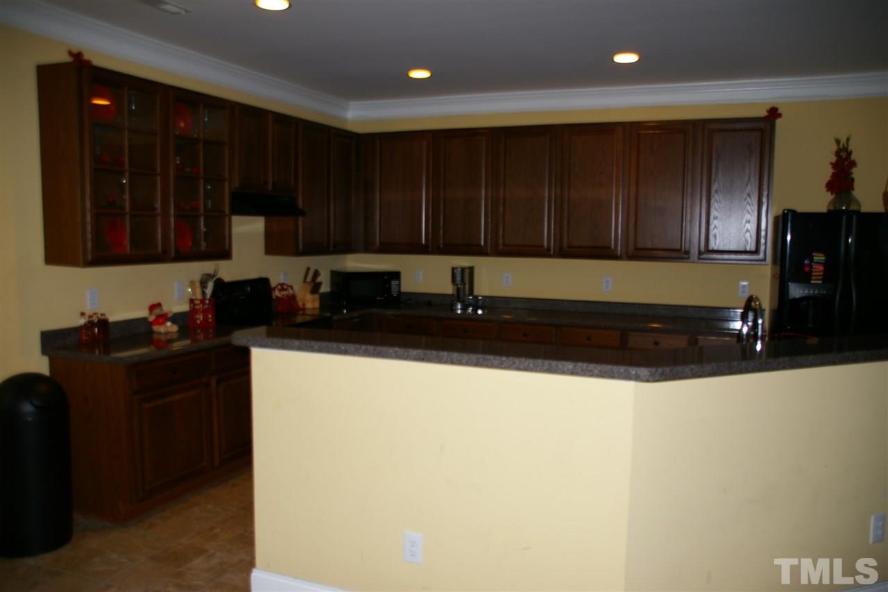 5245 Thornton Road Raleigh, NC 27616 - Photo 7 of 9 a kitchen with a sink and cabinets
