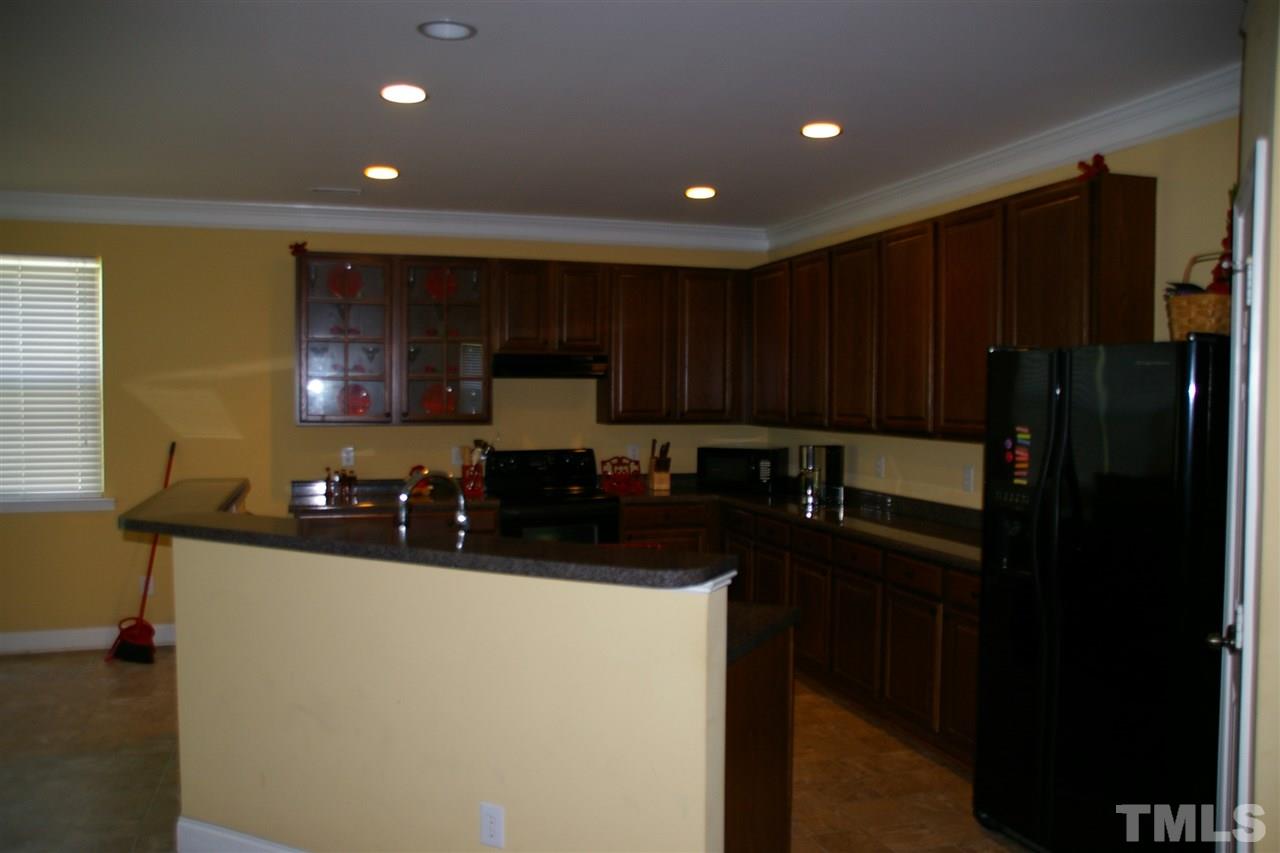 5245 Thornton Road Raleigh, NC 27616 - Photo 8 of 9 a kitchen with sink a refrigerator and cabinets