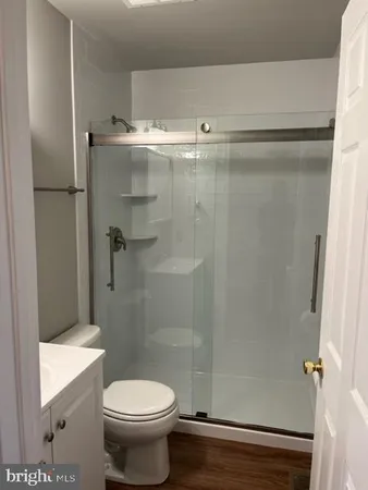 a bathroom with a toilet and a shower