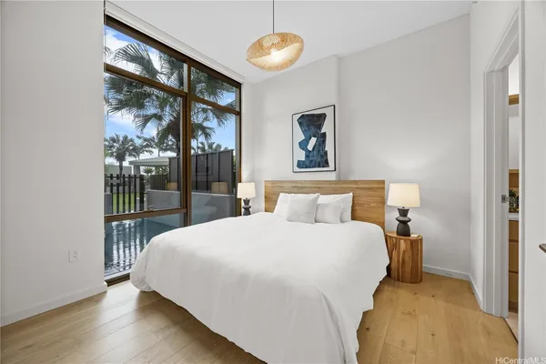 a bedroom with a large bed and a chandelier