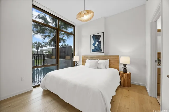 a bedroom with a large bed and a chandelier