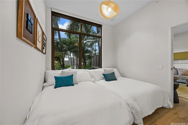 a bedroom with a large bed and a large window
