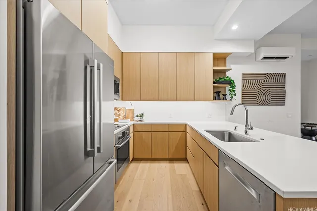 a kitchen with a sink refrigerator and microwave