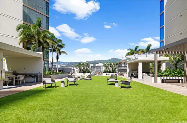 a row of palm trees in front of house