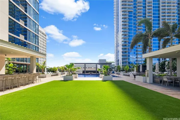 a view of a park with furniture and a swimming pool