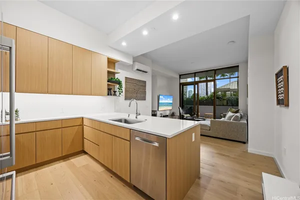 a kitchen with sink cabinets and living room