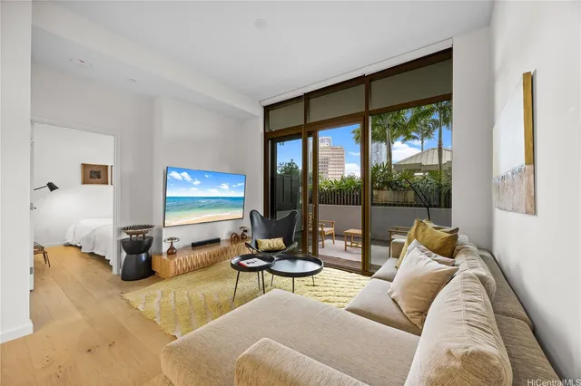 a living room with furniture and large windows