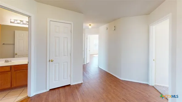 a view of a hallway with wooden floor