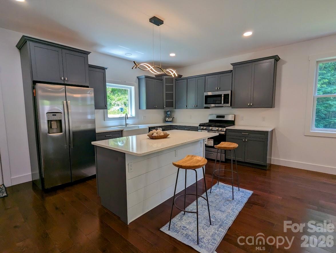 24 Salt Burnsville, NC 28714 - Photo 15 of 42 a kitchen with stainless steel appliances granite countertop a refrigerator a sink a stove and cabinets