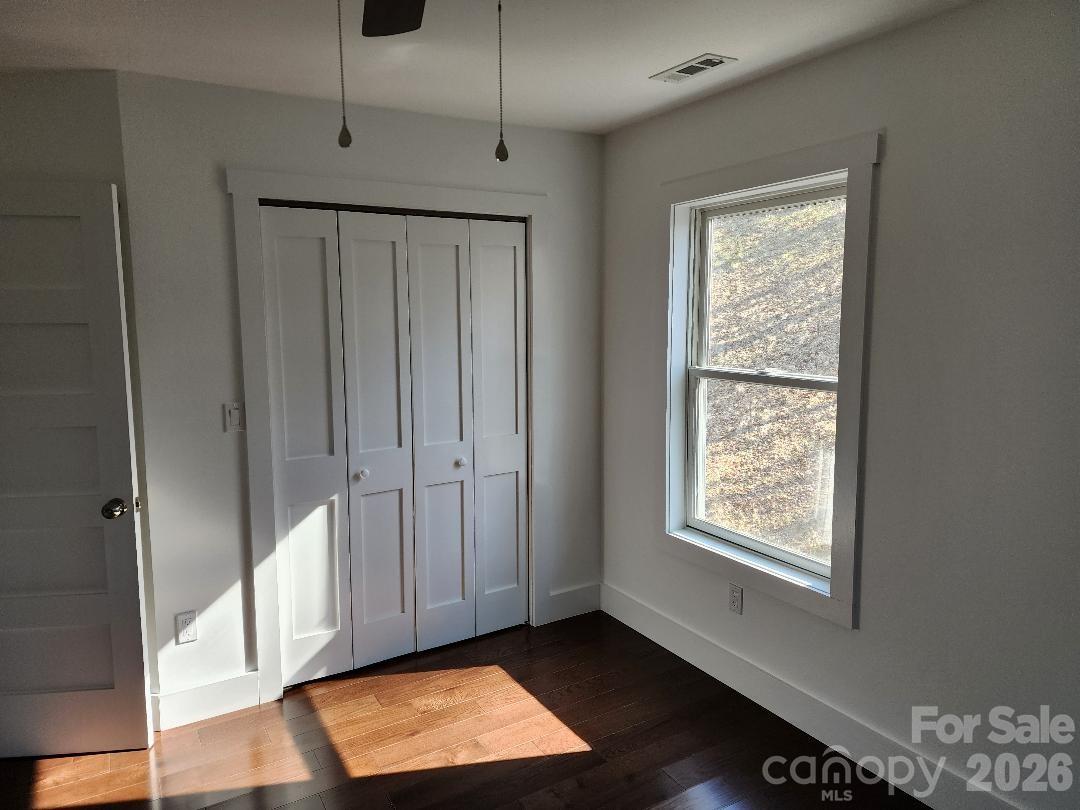 24 Salt Burnsville, NC 28714 - Photo 25 of 42 a view of an empty room with wooden floor and a window