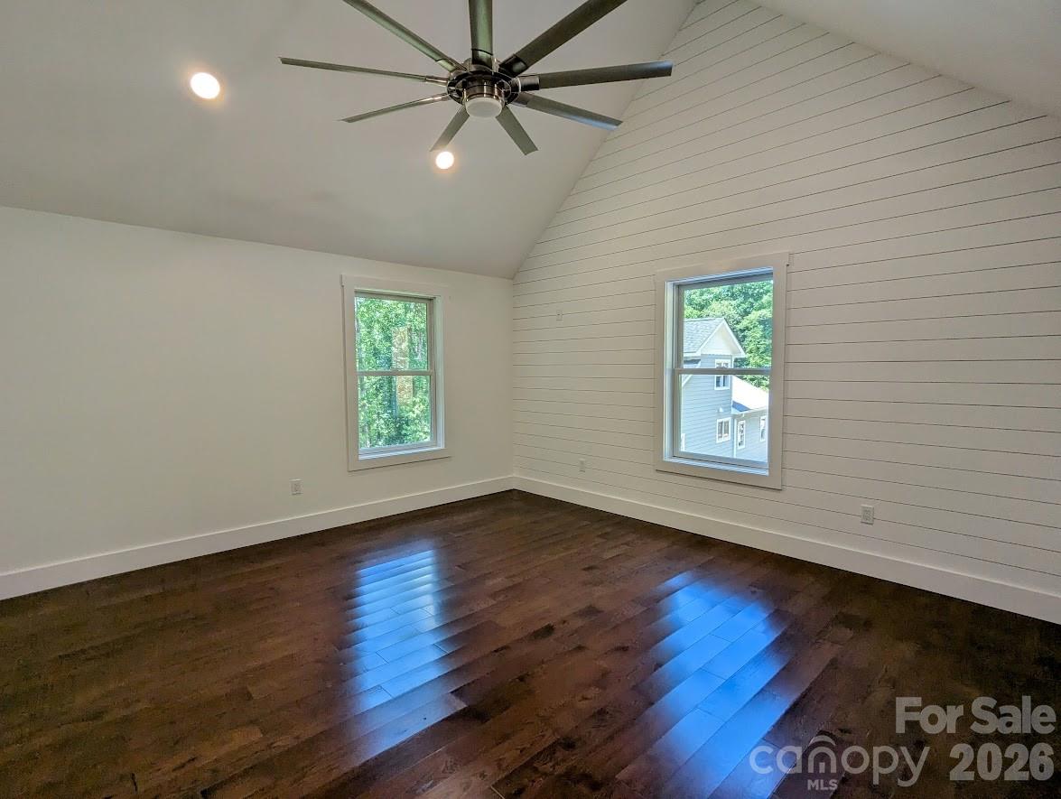 24 Salt Burnsville, NC 28714 - Photo 31 of 42 an empty room with wooden floor chandelier fan and windows