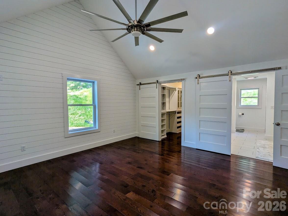 24 Salt Burnsville, NC 28714 - Photo 33 of 42 an empty room with wooden floor chandelier fan and windows