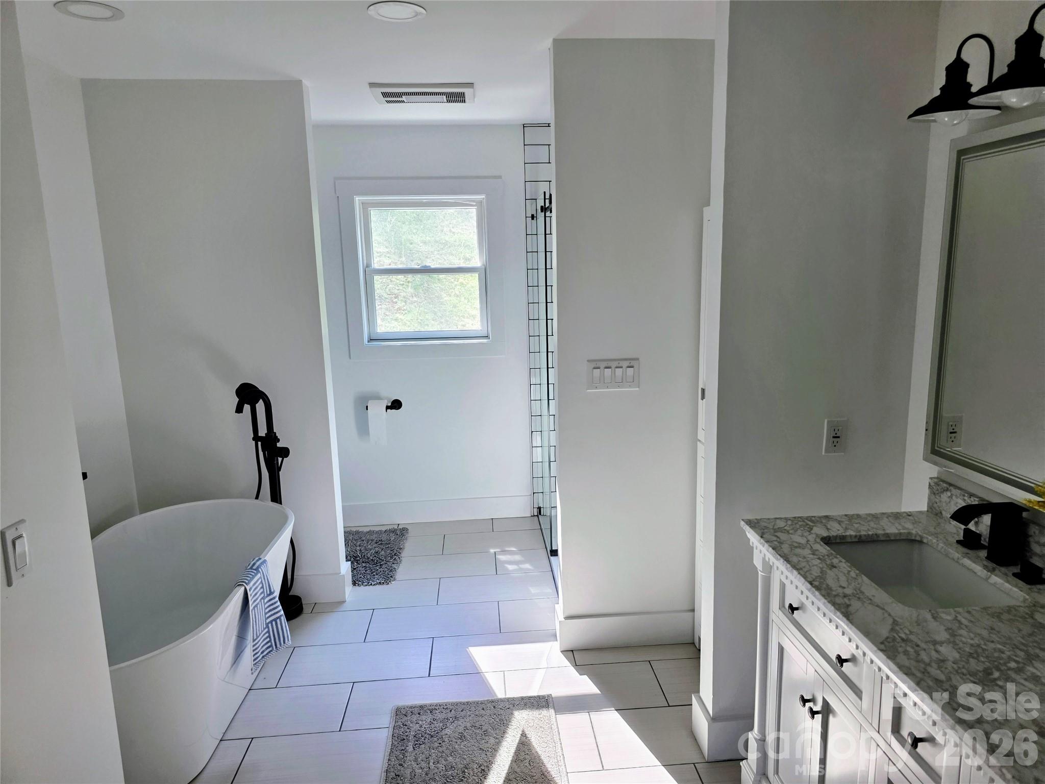 24 Salt Burnsville, NC 28714 - Photo 37 of 42 a bathroom with a granite countertop sink a toilet and mirror