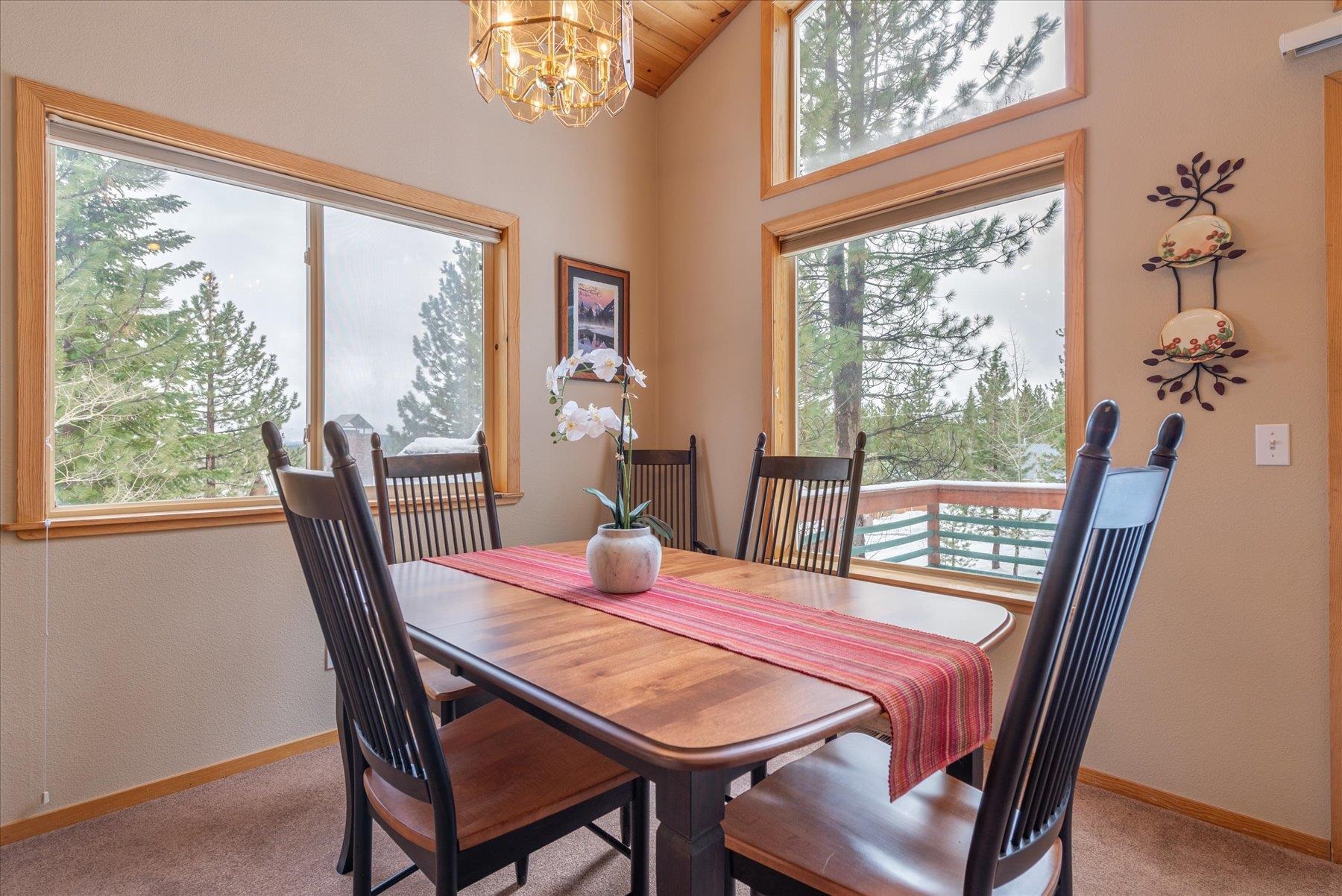 14236 Wolfgang Road Truckee, CA 96161 - Photo 5 of 21 a view of a dining room with furniture a chandelier and wooden floor