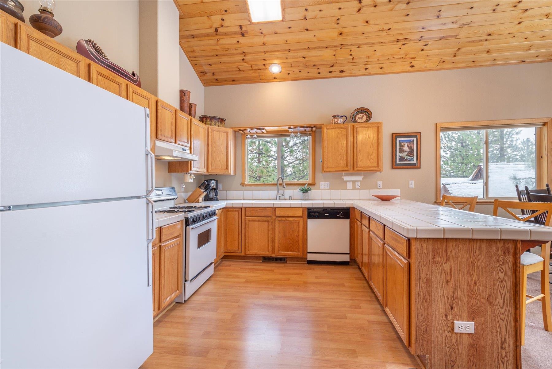 14236 Wolfgang Road Truckee, CA 96161 - Photo 8 of 21 a kitchen with stainless steel appliances granite countertop a sink a stove and a refrigerator