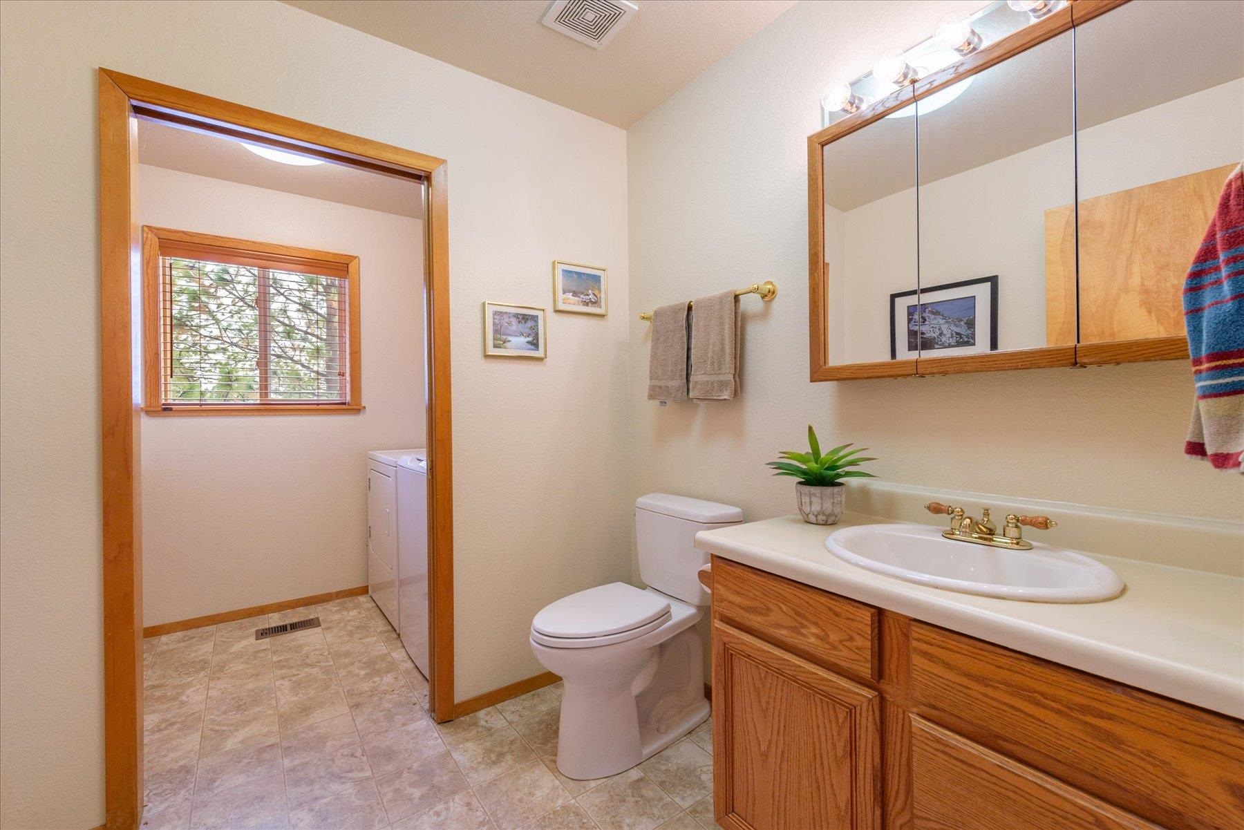 14236 Wolfgang Road Truckee, CA 96161 - Photo 10 of 21 a bathroom with a sink a toilet and mirror