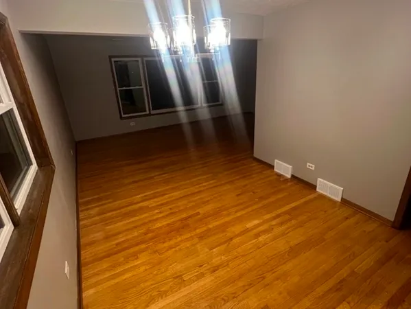 a view of a room with wooden floor and staircase