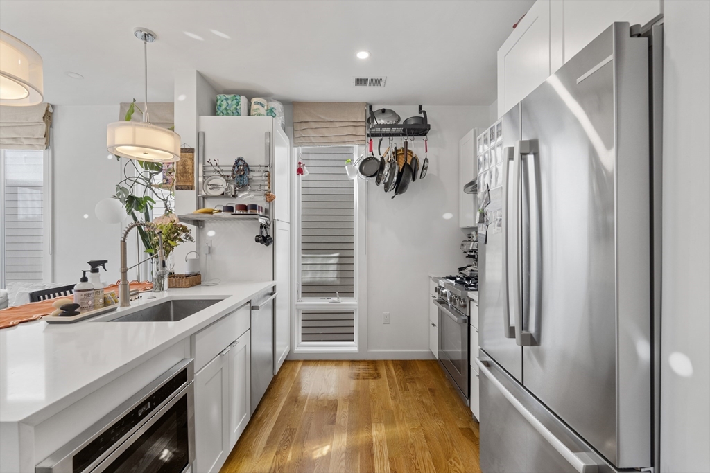 49 Rogers Street, Unit 7 Boston, MA 02127 - Photo 2 of 11 a kitchen with a refrigerator and a sink