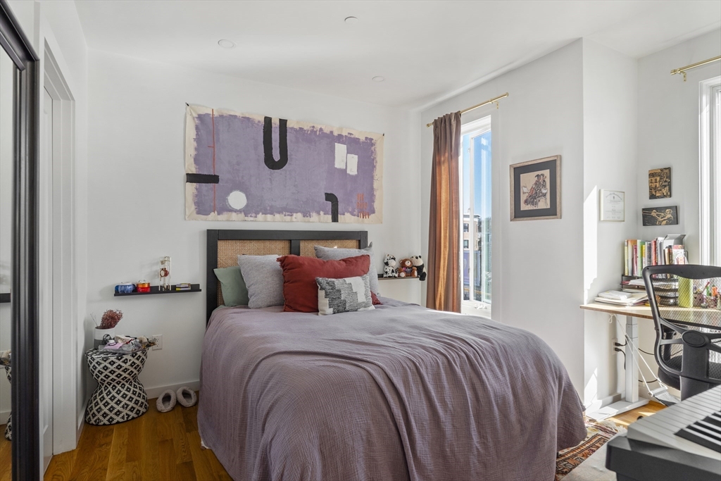 49 Rogers Street, Unit 7 Boston, MA 02127 - Photo 6 of 11 a large bed sitting in a bedroom next to a window