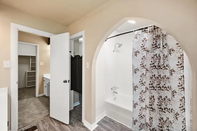 a bathroom with a shower and a sink