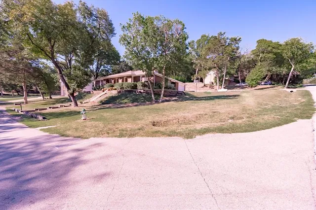 a view of a swimming pool with a house in the background