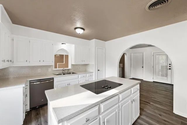 a kitchen with a sink stove and refrigerator