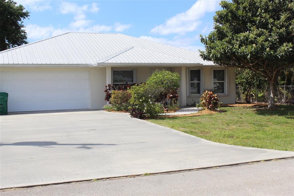 2422 Southeast 33rd Street Okeechobee, FL 34974 - Photo 1 of 32 a front view of a house with garden
