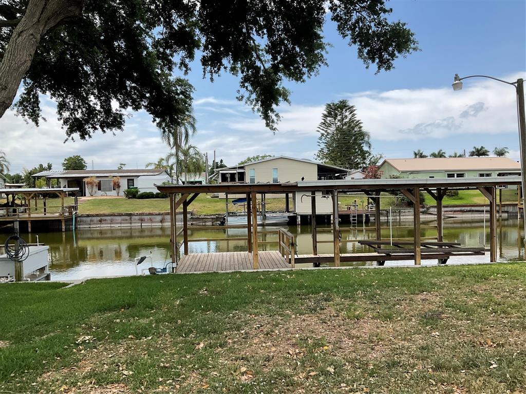 2422 Southeast 33rd Street Okeechobee, FL 34974 - Photo 28 of 32 a view of a house with a big yard and sitting area